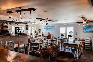 a restaurant with people sitting at tables and chairs at Little Pig Glamping in Bude