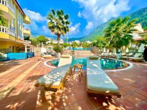 a resort with a swimming pool and mountains in the background at Mountain Valley Oludeniz in Oludeniz