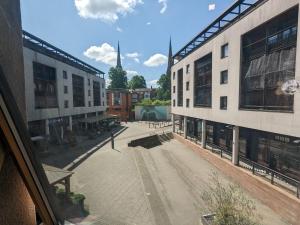 a view of an empty street between two buildings at Beautiful Modern Coventry City Centre Apartment in Coventry