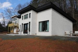 a white house with a black roof at Golf Views Mount Airy in Mount Airy