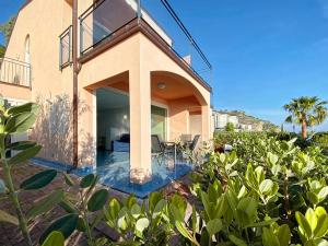 a house with a balcony and a swimming pool at Grand Bleu Magarà in Cefalù