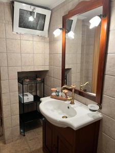 a bathroom with a sink and a mirror at Villa Maria - Koropi in Koropíon