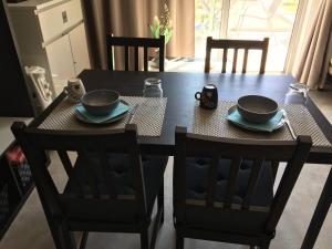 a table with two chairs and two bowls on top at Studio 12 in Han-sur-Lesse