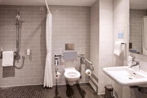 a bathroom with a toilet and a sink at Holiday Inn Express Oberhausen, an IHG Hotel in Oberhausen