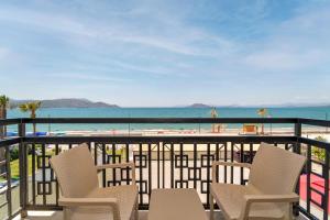a balcony with chairs and a view of the beach at Uras Beach Hotel in Fethiye