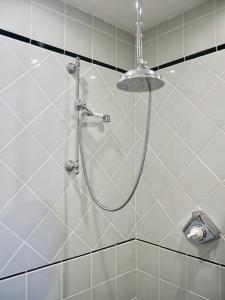 a shower with a shower head in a bathroom at Manoir au coeur du triangle d or au Touquet in Le Touquet-Paris-Plage