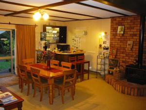 a dining room with a wooden table and chairs at Mount Tutu Eco-Sanctuary in Ohauiti