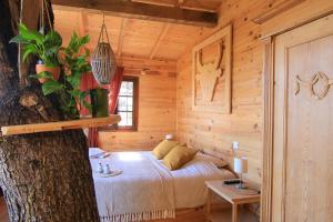 a bedroom with a bed in a log cabin at Cabane dans les arbres au coeur d'un vignoble in Sorgues