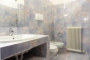 łazienka z umywalką, toaletą i grzejnikiem w obiekcie Casa Marilla w Weronie