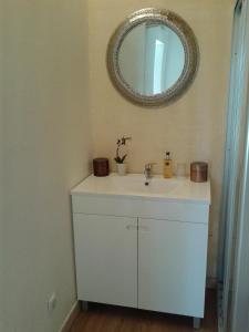 a bathroom with a white sink and a mirror at Taipa 2 - Casas de Campo do Junqueirinho in Bicos +22 photos