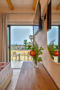 a living room with a table and a mirror at Despo Hotel in Gouves +27 photos
