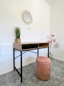 a desk with a round mirror and a stool at Rab City Apartment Greeny in Rab