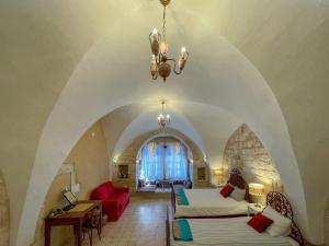 a bedroom with two beds and a living room at Dar al Majus in Bethlehem