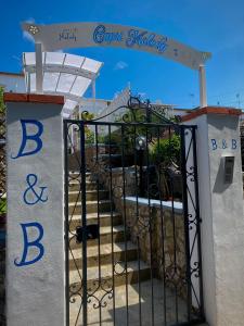 a black gate with a sign on top of it at Capri Melody in Anacapri
