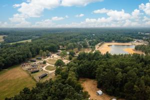 an aerial view of a house and a lake at Resort Wilsumer Berge in Wilsum