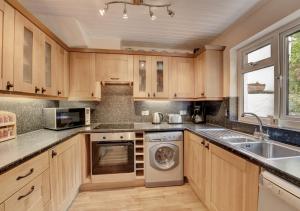 a kitchen with wooden cabinets and a dishwasher at Fairview in Dartmouth