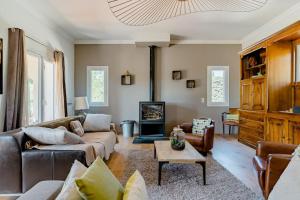 a living room with a couch and a fireplace at Mas provençal avec vue sur la Sainte Victoire in Aix-en-Provence