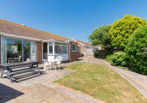 a house with a picnic table and a patio at Bidwell Brook in Paignton