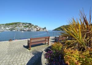 two benches sitting next to a body of water at Number 17 in Dartmouth
