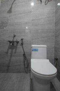 a bathroom with a toilet and a shower at Arjuna Luxury Rooms in Hyderabad +19 photos