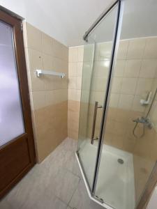 a shower with a glass door in a bathroom at Kherim in Vama Veche