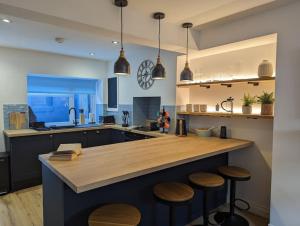 a kitchen with a large island with wooden counter tops at Luxury holiday home in central Truro in Truro