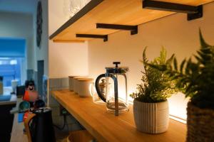 a counter with a tea kettle and potted plants on it at Luxury holiday home in central Truro in Truro