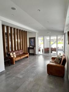 a living room with two couches and a couch at Villa Hara Suites in Paralia Katerinis