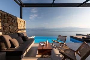 a living room with a view of the water at ​Le Grand Bleu Resort in Derveni