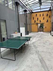 a room with a ping pong table in it at Apparthotel CASA IDEALE LECCO in Lecco