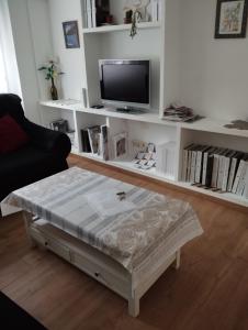 a living room with a coffee table and a tv at Apartamento luminoso y nuevo en Madrid Rio in Madrid