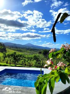 a swimming pool with a view of the mountains at Vista al Volcán Tenorio y Montaña in San Rafael