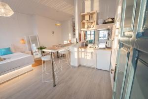 a small kitchen with a table and chairs in a room at The White Rose Apartment in Poros