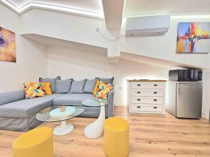 a living room with a couch and a table at Art Apartment + 2BD parking space in Varna City