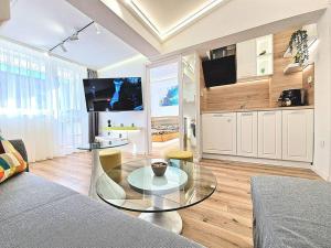 a living room with a glass table in a room at Art Apartment + 2BD parking space in Varna City