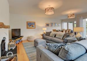 a living room with two couches and a bed at Riverside House in South Pool