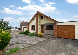 a house with a garage and a driveway at Avalon in Brixham