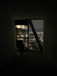 a chair sitting in a room with a window at Spencer St 1bd Lvl 47 Melbourne CBD in Melbourne