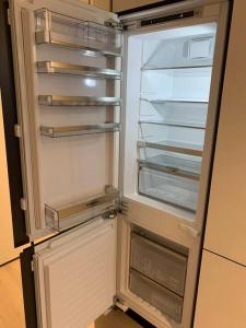 an empty refrigerator with its door open in a kitchen at Spencer St 1bd Lvl 47 Melbourne CBD in Melbourne
