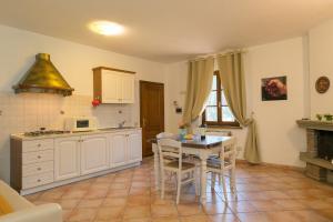 a kitchen with a table and a counter top at Podere Nuti - 3 Vallino in Cecina +18 photos