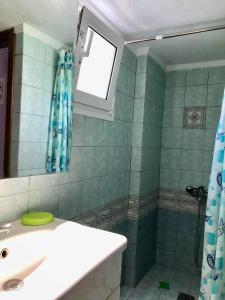 a bathroom with a sink and a shower at Mina Apartments 4 Nea Kallikrateia in Nea Kalikratia