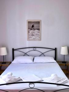 a bedroom with a large white bed with two lamps at Mina Apartments 4 Nea Kallikrateia in Nea Kalikratia