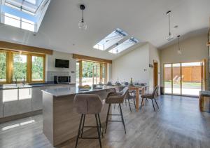 a kitchen with a table and chairs in a room at The Meadows 