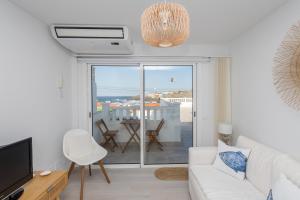 a living room with a white couch and a balcony at Sea Views Private Terrace 2BR House near the Beach in Telde