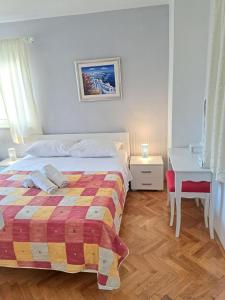 a white bedroom with a bed and a table at Guesthouse Villa Stanovic Vlaho in Cavtat +10 photos