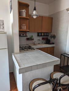 a kitchen with a stove and a counter top at Ponza Holiday Homes - Porto in Ponza