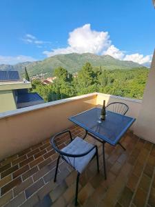 a blue table and chairs on a balcony with a view at Guesthouse Villa Stanovic Vlaho in Cavtat