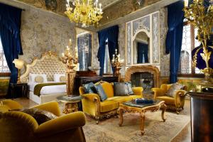 a bedroom with a bed and a couch and a table at Palazzo Venart Luxury Hotel in Venice