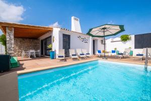a villa with a swimming pool and a house at Villa Belize by Algarve Vacation in Albufeira