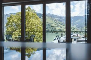 a view of a lake from a window at The Gast House Zell am See in Zell am See